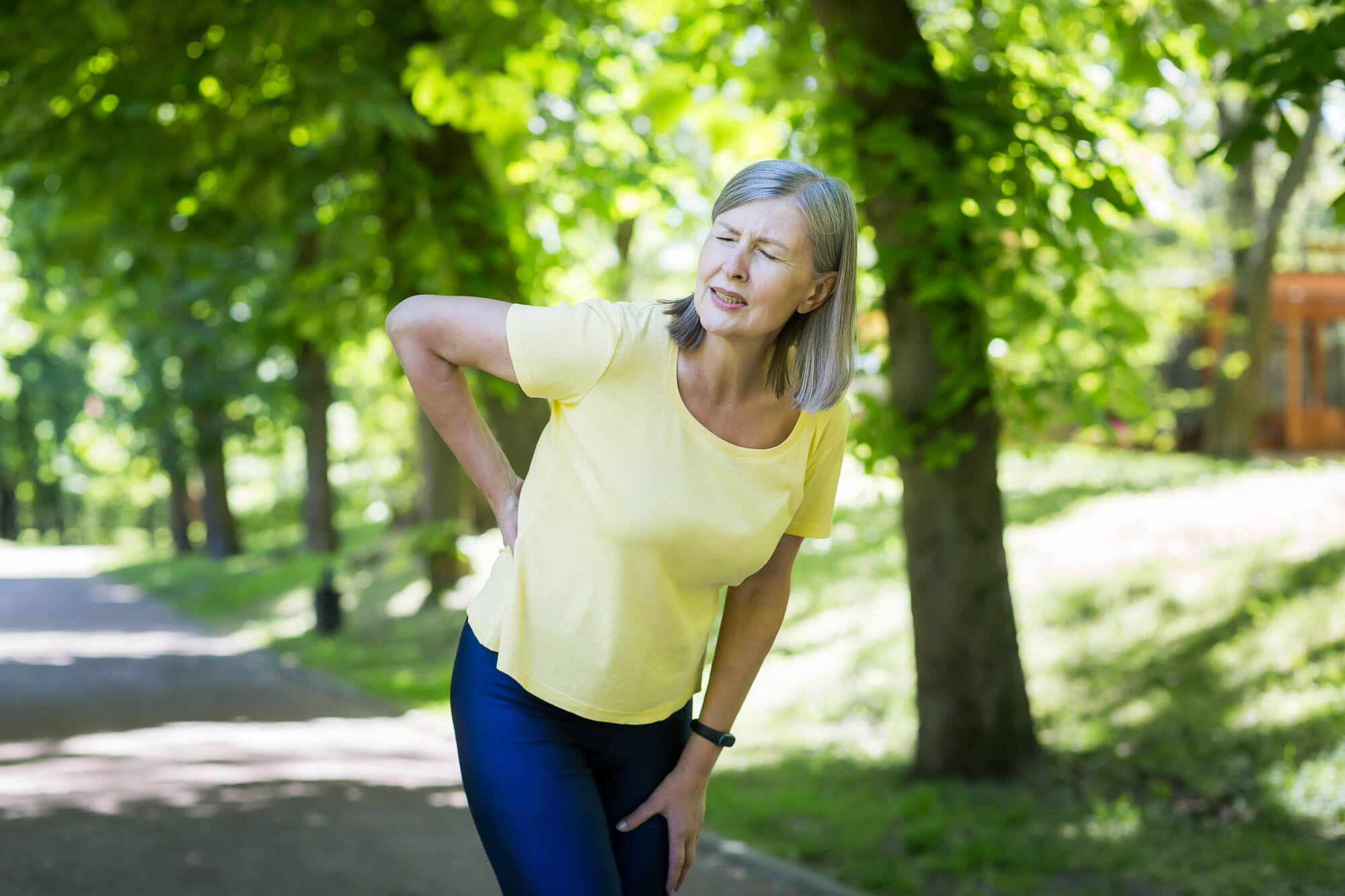 Woman feeling a back pain when walking, Albuquerque